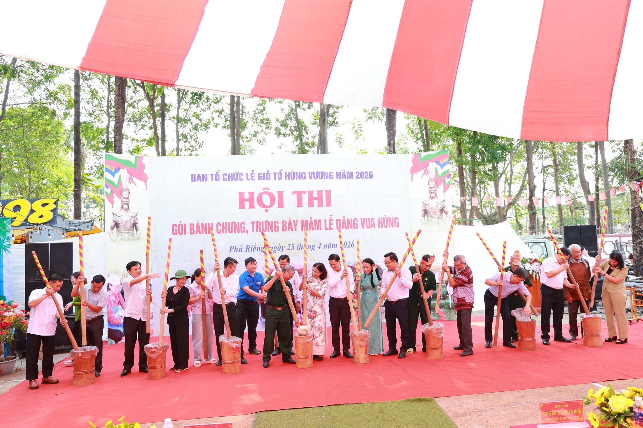 'A group of people holding bamboo sticks

Description automatically generated'